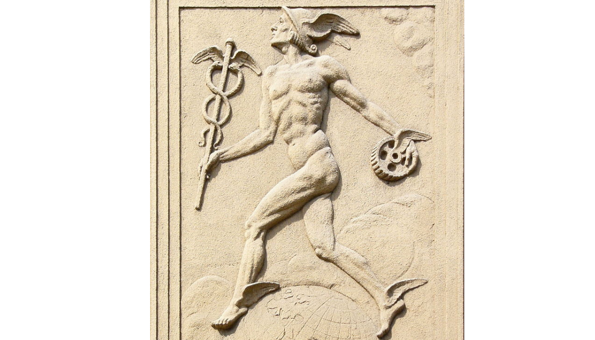 relief of Mercury (or of Hermes) at Obchodní akademie (Business Academy) building, at tř. Spojenců 11 in Olomouc. The God is wearing winged cap (petasus), wearing winged sandals (talaria), and carrying his staff caduceus and a winged wheel.